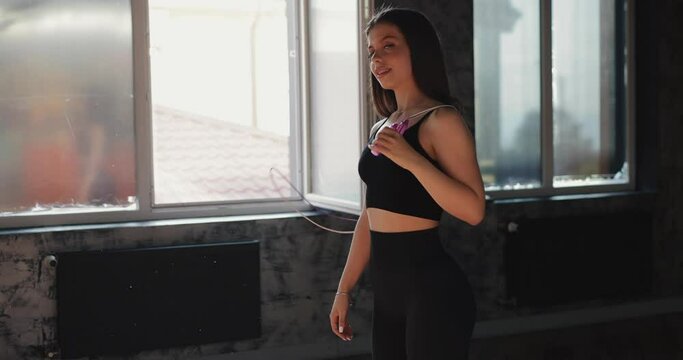 Beautiful Woman Portrait Holding Skipping Rope In The Gym Looking At The Camera, Slow Motion