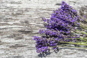 flat layout of bunch of lavenders on wooden background