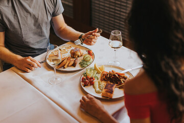 Young couple having lunch with white wine in the restaurant