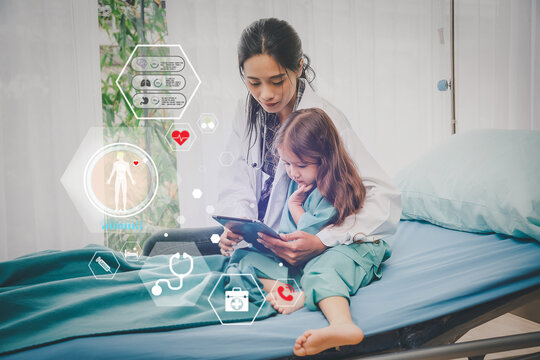 Asian Female Doctor Using Digital Tablet on virtual medical network connection icons to small child patient. people awareness and spread attention on their healthcare
