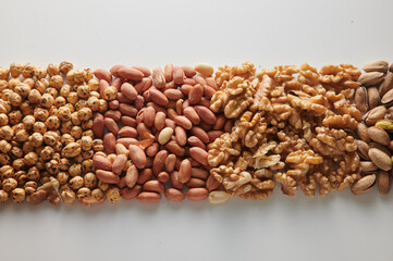 Mix of tasty nuts on white surface