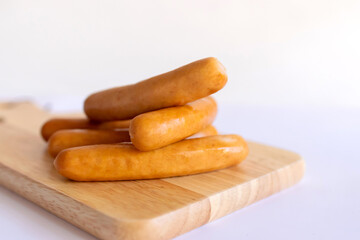 Sausage on wooden cutting board.