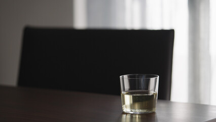 white wine into glass on walnut table