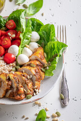 Fresh Caesar salad with tomatoes and corn and pearl barley.