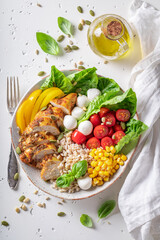 Fit Caesar salad with tomatoes and corn and pearl barley.