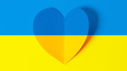 Stop war in Ukraine concept with heart and Ukrainian flag background