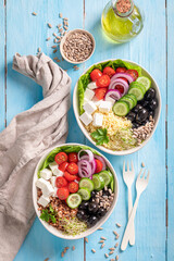 Healthy Greek salad with groats, feta cheese and vegetables.