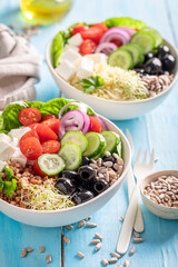 Colorful Greek salad with groats, feta cheese and vegetables.