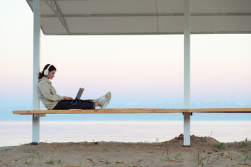 Freelancer working outside with beautiful background of mountains and lake