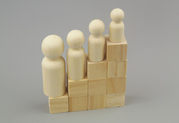 Degradation people in career and politics concept. Different wooden people figures on stair made of...