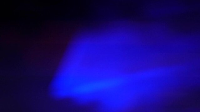 Light laser show on a black background of the night sky, outdoor performance. Multi-colored laser beams turn into various shapes, projection on smoke. Information Technology Conference