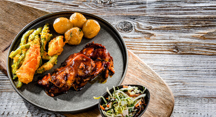 Chicken thighs in tamarind sauce with veggies tempura and potato