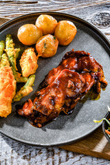 Chicken thighs in tamarind sauce with veggies tempura and potato