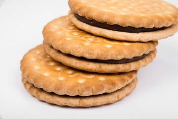 Crispy sandwich biscuits with fluffy cream on a white