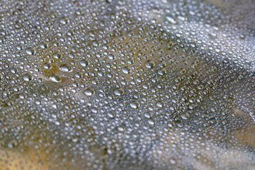 Transparent surface with many water drops of different sizes