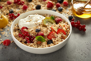 Delicious oat with berries and fruits in bowl on table
