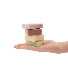 Handmade soap bars with organic ingredients on palm of hand on white background. Homemade beauty products with natural essential oils from plants and flowers. Body care, aromatherapy.