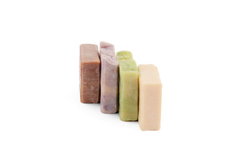 Handmade soap bars with organic ingredients on white background. Homemade beauty products with natural essential oils from plants and flowers. Body care, aromatherapy.