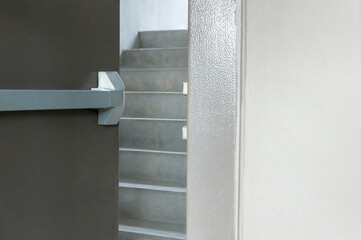 Emergency fire exit door. Closed up latch and rusty door handle of emergency exit. Push bar and...