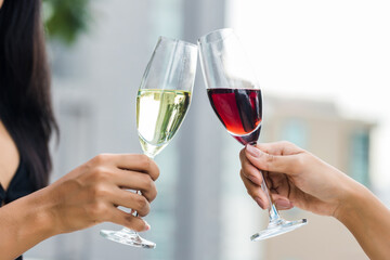 Cheers!  People cheering with champagne .  Wine Glasses Hitting Together at outdoor. Friend clinking glasses with champagne