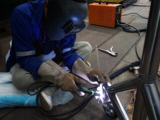 Worker, Welder Sitting welding work