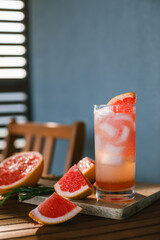 Paloma cocktail made with tequila blanco, syrup, grapefruit juice and sparkling water garnished...