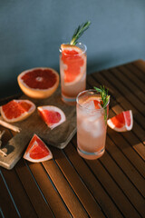 Summer drinks on table. Sparkling cocktails pink Paloma.