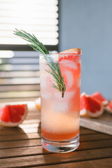 Close-up of summer drink on table. Sparkling cocktail pink Paloma.