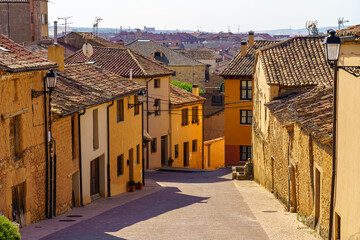 Fototapeta na wymiar Picturesque alley of colorful old houses in the medieval village of San Esteban de Gormaz.