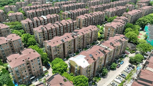 Residential buildings with red roof in downtown. Drone aerial view. Buildings in rows in sunny day in Shanghai China.  Economy city scape, house development  concept b-roll footage.