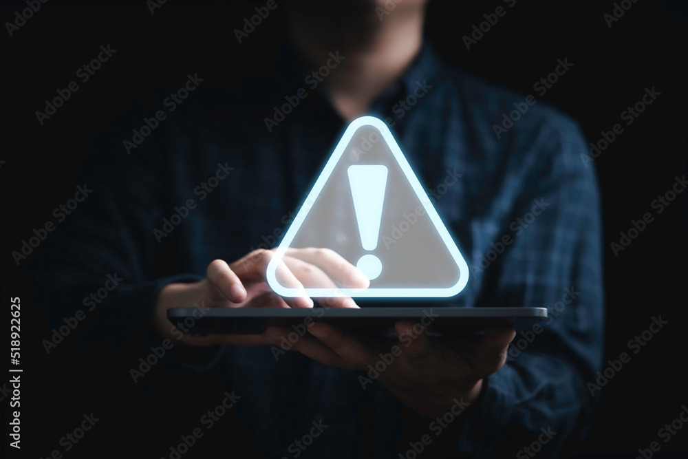Poster businessman holding tablet with triangle caution warning sing for notification error and maintenance