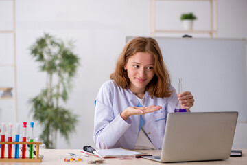 Young female chemist working at the lab