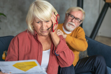 Upset of elderly couple received a utility bill for gas or electricity. Bank loan debt, tax payment...