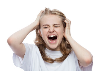 The teenager screams holding his head. young girl in a white shirt. Negative emotions and stress. White background. Close-up.