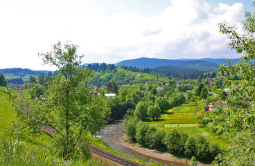 Fototapeta na wymiar Landscape in the village Vorokhta with railroad in the Carpathian Mountains, Ukraine 