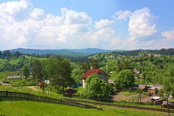 Fototapeta na wymiar Landscape in the village Vorokhta with railroad in the Carpathian Mountains, Ukraine 