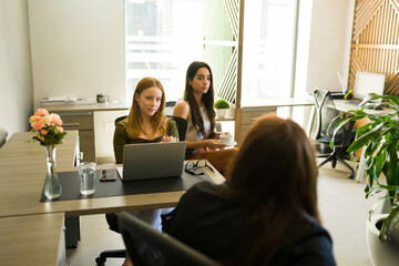 Female workers at their desks in an all women workplace