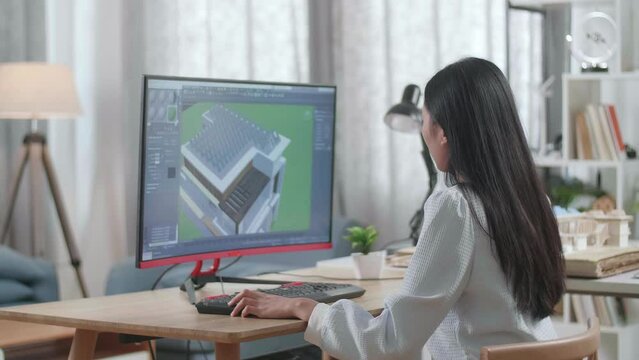 Asian Woman Engineer Design And Zoom In 3D House With Solar Pannel While Working On A Desktop At Home. Cyber Games House Design And Decoration
