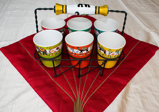 Ceramic empty Tea glasses in black metal glass holder. red background.	