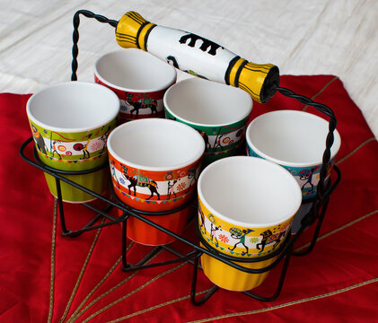 Ceramic empty Tea glasses in black metal glass holder. red background.	