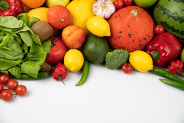 Fitness concept. Healthy nutrition: fruits and vegetables. Equipment for fitness exercises: weighing machine and dumbells. White background.