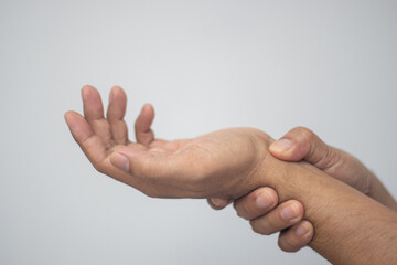 man holding hands with aching wrist