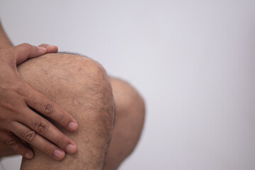 Joint pain, arthritis and tendon problems. A man touches the pain point