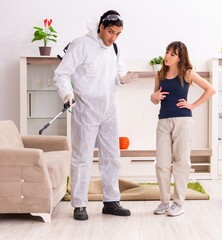 Fototapeta premium Young professional contractor doing pest control at flat