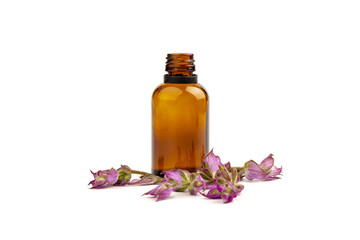 A bottle of essential oil with fresh blooming clary sage twigs on white background.