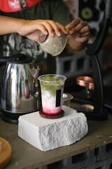 Iced matcha green tea with green straw