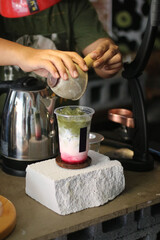 Iced matcha green tea with green straw