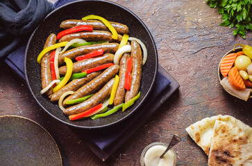 Arabic cuisine; Egyptian traditional sausage with onions, bell peppers and chili peppers. Served...