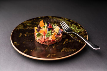 plate with delicious tuna tartar with coloured plate, and fork, 