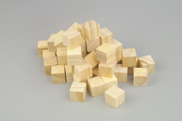 Many wooden cubes on gray background.